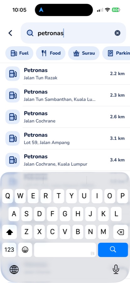 Manotu search screen: results for petronas with distance on the right, and Fuel, Food, Surau and Parking chips